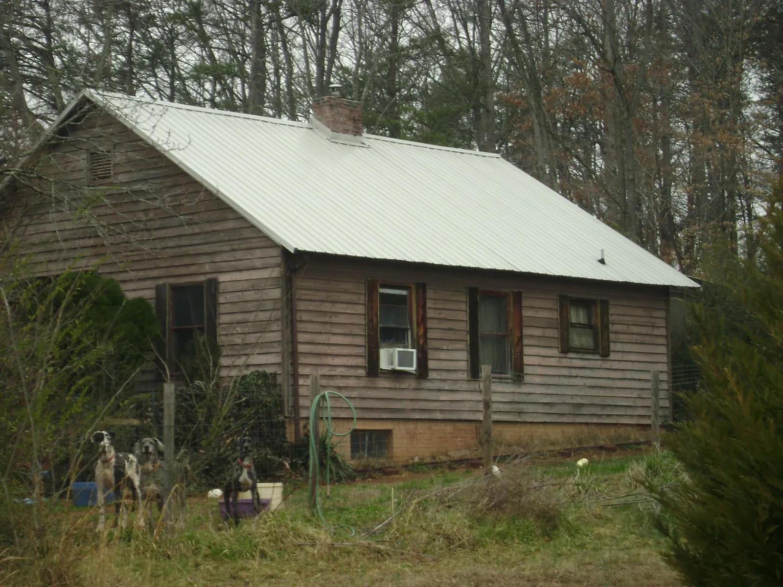 White metal roof on an old wood sided farmhouse, from a Metal Roof Installation job in Tracy City